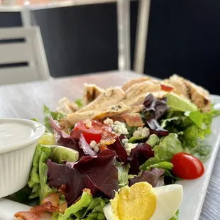 Grilled Chicken Cobb Salad Brunch ($15) avocado, bacon, bleu cheese crumbles, egg.