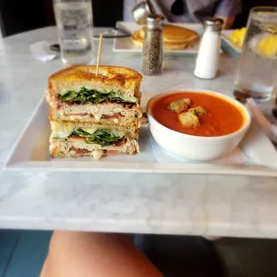 Grilled cheese turkey cranberry sandwich and tomato soup.