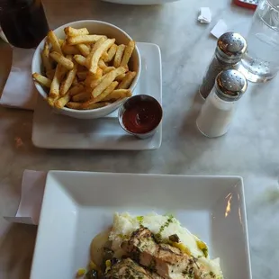 Lobster Caesar salad, side of fries, and herb-marinated grilled chicken plate