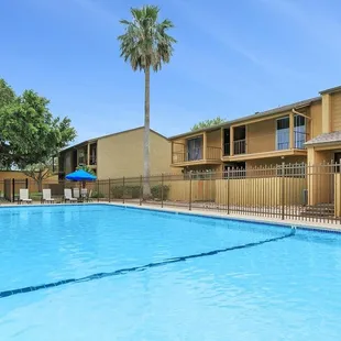 Residents can enjoy community amenities including free covered parking, a playground, and two sparkling swimming pools
