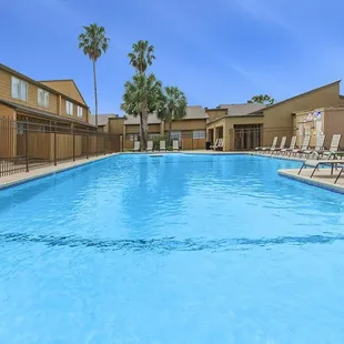 Residents can enjoy community amenities including free covered parking, a playground, and two sparkling swimming pools