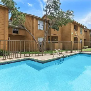 Residents can enjoy community amenities including free covered parking, a playground, and two sparkling swimming pools.