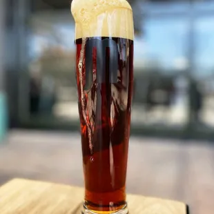 a pint of beer on a wooden table