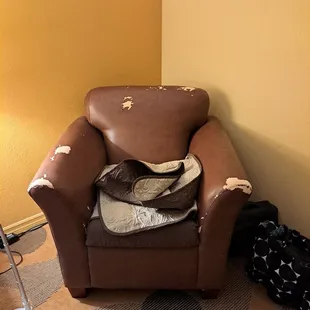 Chair in my room with a little cover over it to hide all the rips