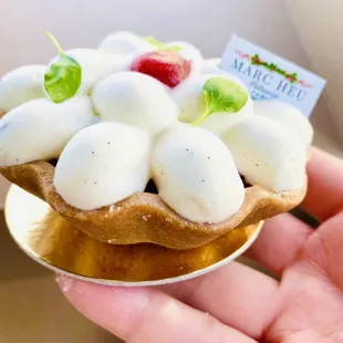 a hand holding a pastry