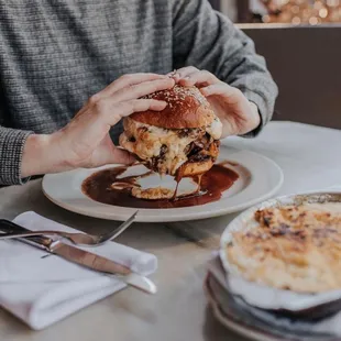 a man eating a burger at a restaurant