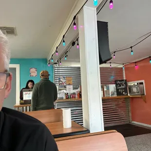 a man sitting at a table in a restaurant