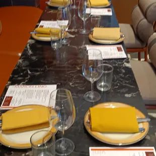 a table set with wine glasses and plates