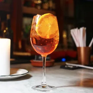 a glass of wine and a candle