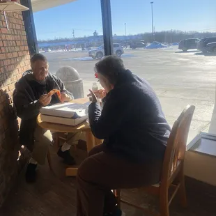 What a lovely couple to share a tasty pizza in a sunny afternoon together!