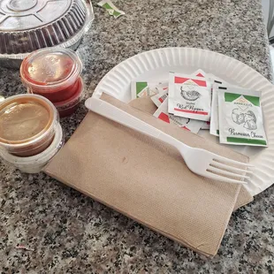 Plates, napkins, utensils, sauce, dressing, red pepper and parmesan cheese included