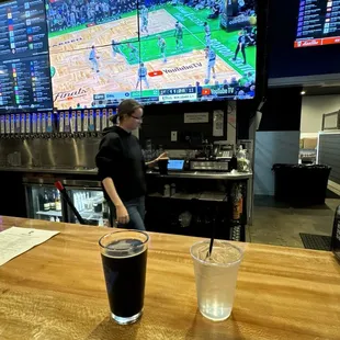 Wide screen tv behind the bar, chocolate cherry stout, and a cup of ice water