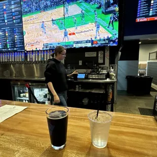 One of two giant screens along the bar (my Cherry Chocolate Stout and water are in the foreground, an awesome server in the background)