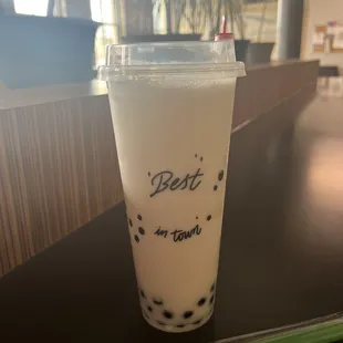 a drink in a plastic cup on a table