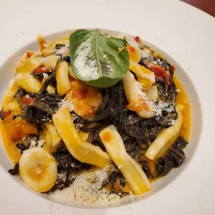 Squid Ink pasta with calamari and shrimp in a light tomato sauce. Delish.
