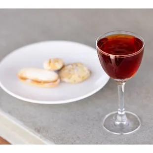 a glass of wine and a plate of cookies