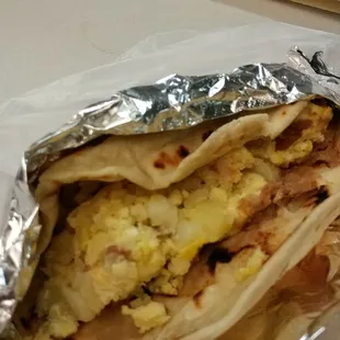 a breakfast burrito wrapped in foil