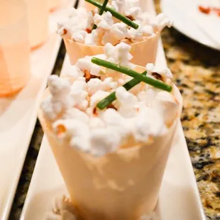 a row of popcorn cups on a table