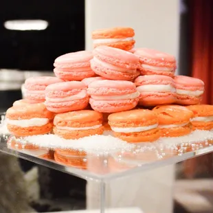 a stack of orange and white macarons