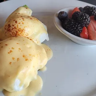 Crab cake eggs Benedict with berries.