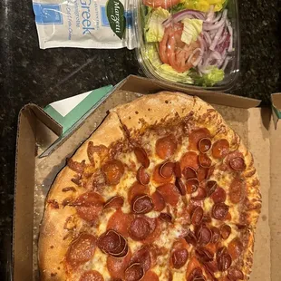 a pepperoni pizza and salad