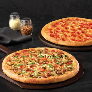 two pizzas on a table