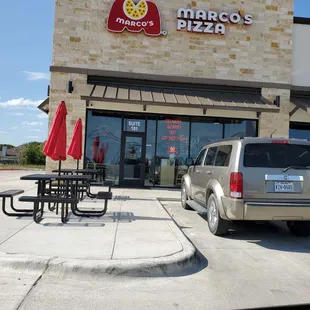 a car parked in front of a restaurant