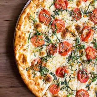 a pizza with tomatoes and basil