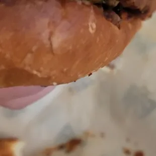 a hand holding a half eaten sandwich