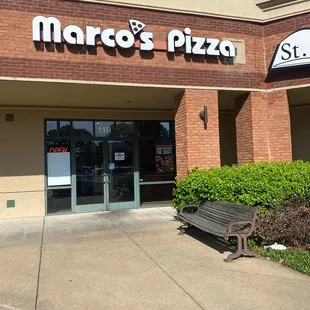 a bench in front of a restaurant