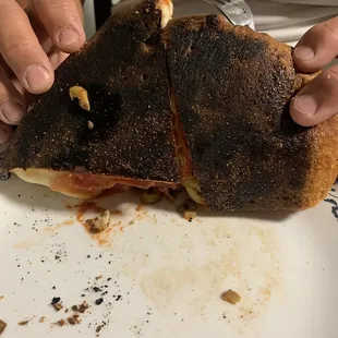 a person holding a half eaten sandwich