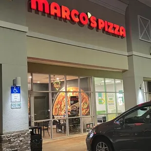 a car parked in front of a restaurant