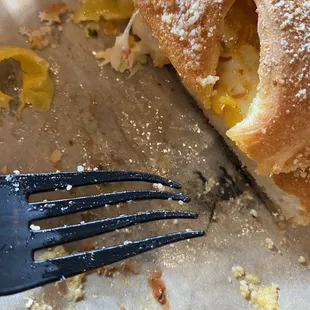 a half eaten sandwich and a fork