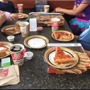 a group of children eating pizza
