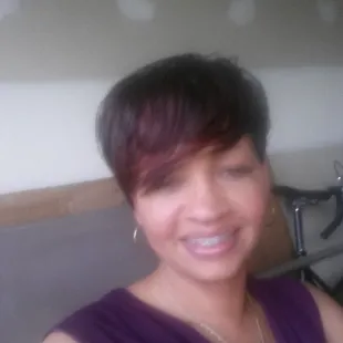 a smiling woman with a bike in the background