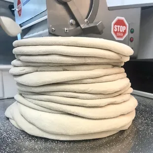 a stack of uncooked pizza dough