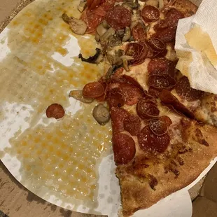 The entire pizza was soaked in grease. This is what underneath the pizza looked like. Couldn&apos;t eat it. Disappointed. Price was almost $20