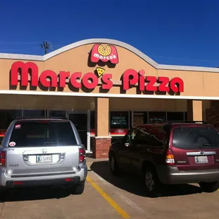 two cars parked in front of a restaurant