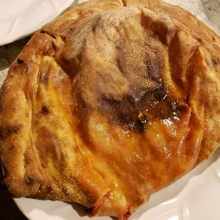 a piece of pizza on a plate