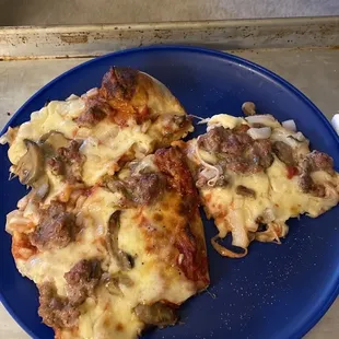  two slices of pizza on a blue plate