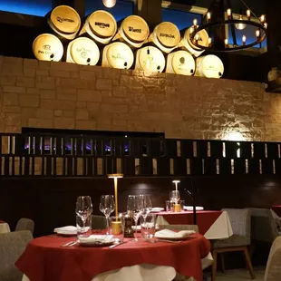 a dining room with wine barrels on the wall