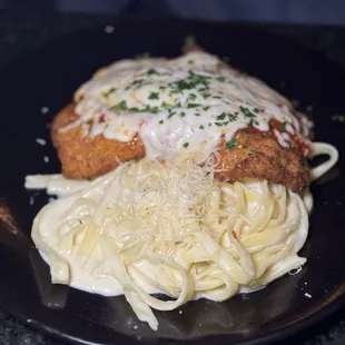 Chicken Parmigiana with fettuccine Alfredo.