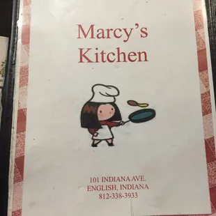 a cook holding a frying pan