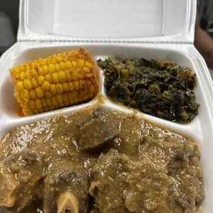 Oxtail's, White Rice and gravy, with Cajun corn, and Collard greens...had to ask for Cornbread an additional $2.17