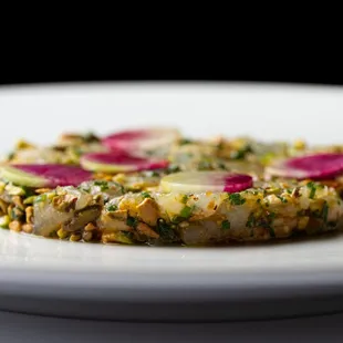 Branzino appetizer - sea bass tartare, pistachio, calabrian chile, radish, chive. at Marea Beverly Hills