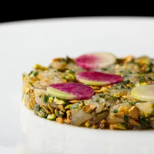 Branzino appetizer - sea bass tartare, pistachio, calabrian chile, radish, chive. at Marea Beverly Hills