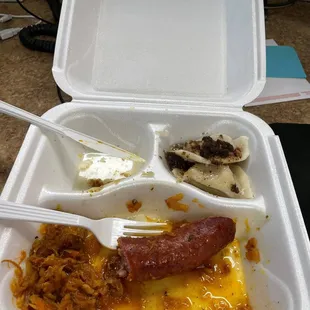 a hot dog in a styrofoam container