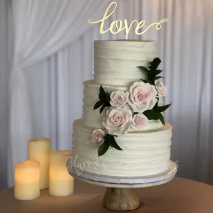 Buttercream cake with sugar flowers.    www.marescustomcakes.com