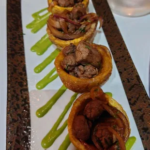 Fried green plantains(tostones) cups stuffed with steak. Delicious. The green sauce was the only dissapointing thing...