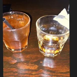 two glasses of alcohol on a table